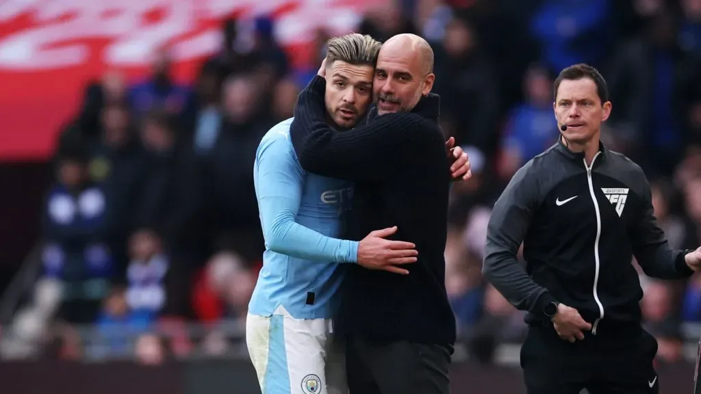 Pep Guardiola embraces Jack Grealish of Manchester City after he is substituted off during the Emirates FA Cup Semi Final match between Manchester City and Chelsea at Wembley Stadium on April 20, 2024 in London, England.