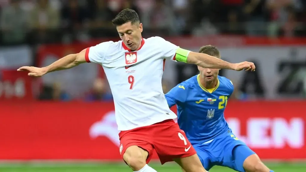Robert Lewandowski of Poland is runs with the ball under pressure from Valeriy Bondar of Ukraine during the international friendly match between Poland and Ukraine at Stadion Narodowy on June 07, 2024 in Warsaw, Poland.