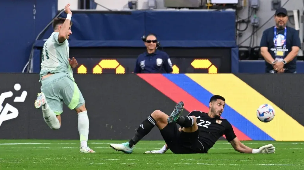 Santiago Gimenez (L) of Mexico fights for the ball with Rafael Romo (L) of Venezuela during the CONMEBOL Copa America 2024 group B match between Venezuela and Mexico,