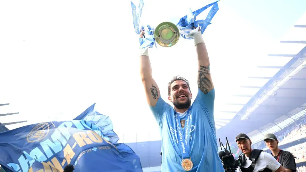 Stefan Ortega of Manchester City celebrates with the Premier League Trophy after their teamās victory in the Premier League match between Manchester City and West Ham United at Etihad Stadium. Michael Regan/Getty Images