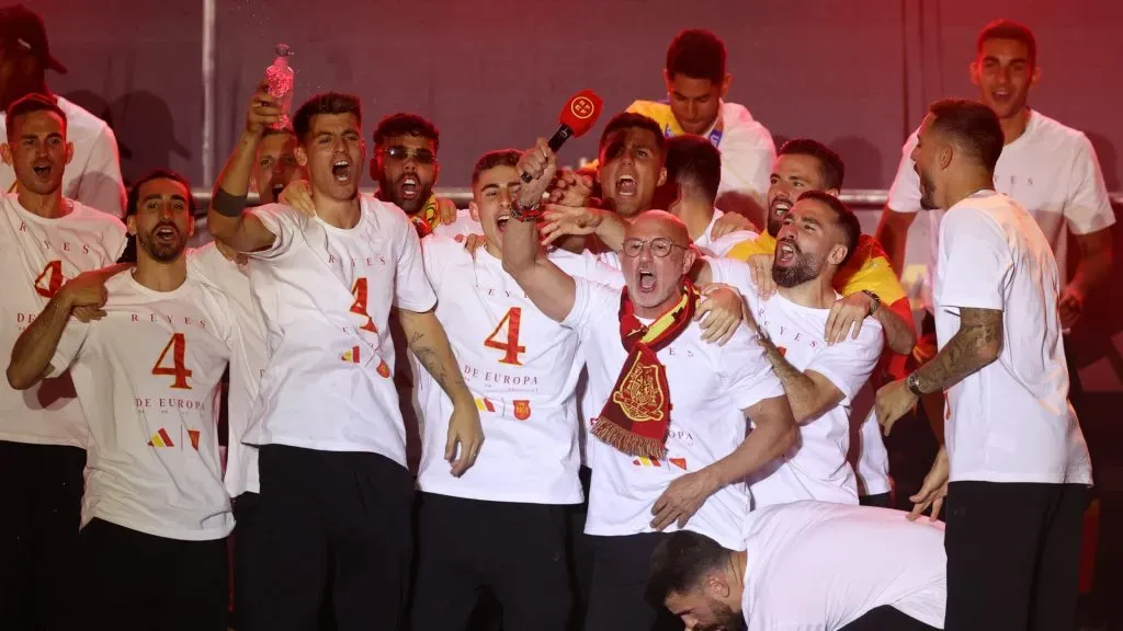 Luis de la Fuente, Head Coach of Spain holds the microphone surrounded by goalkeeper Unai Simon, Daniel Carvajal, Rodrigo, Fermin, Alvaro Morata and Marc Cucurella of Spain during the Spain EURO 2024 Trophy Parade on July 15, 2024 in Madrid, Spain. Photo by Gonzalo Arroyo Moreno/Getty Images