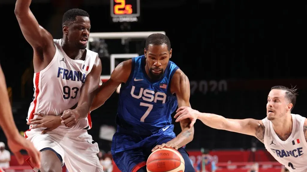 Kevin Durant #7 of Team United States drives past Moustapha Fall #93 and Frank Ntilikina #1 of Team France during the first half of the Men's Preliminary Round Group B game on day two of the Tokyo 2020 Olympic Games at Saitama Super Arena on July 25, 2021 in Saitama, Japan.