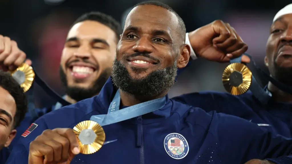 Gold medalist LeBron James poses on the podium with teammates during the Menās basketball medal ceremony. Gregory Shamus/Getty Images
