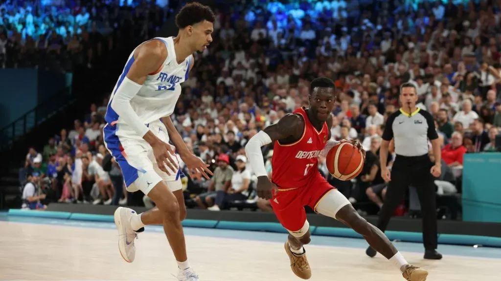 Dennis Schroder #17 of Team Germany drives past Victor Wembanyama #32 of Team France during a Men’s basketball semifinals. Ezra Shaw/Getty Images