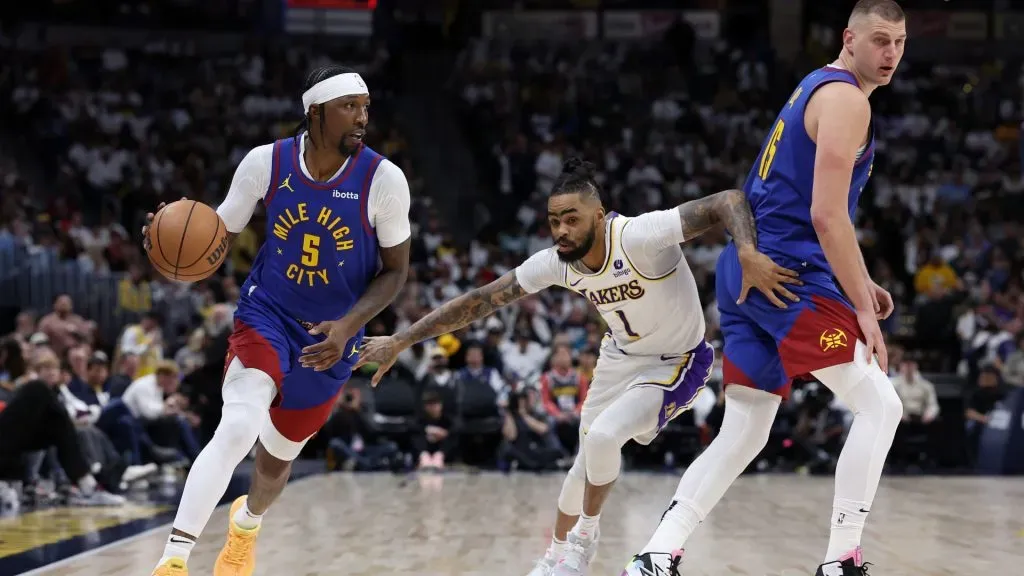 Kentavious Caldwell-Pope #5 of the Denver Nuggets drives against DâAngelo Russell #1 of the Los Angeles Lakers on a pick by Nikola Jokic #15 in the third quarter during game one of the Western Conference First Round Playoffs at Ball Arena. (Photo by Matthew Stockman/Getty Images)