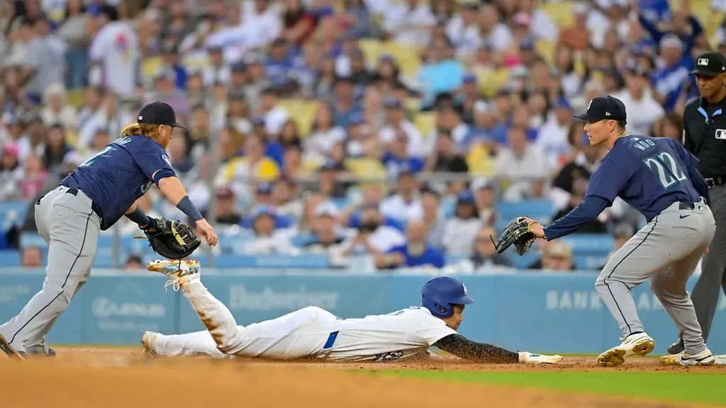 : Shohei Ohtani #17 of the Los Angeles Dodgers is caught in a run-down play as he dives back to first beating the tag by Justin Turner #2 of the Seattle Mariners as Bryan Woo #22 waits on the base in the first inning at Dodger Stadium. (Photo by Jayne Kamin-Oncea/Getty Images)