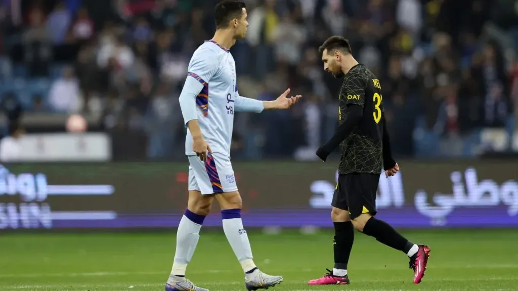 Lionel Messi of Paris Saint-Germain walks past Cristiano Ronaldo of Riyadh XI after scoring the side’s first goal during the Winter Tour 2023 friendly between Paris Saint-Germain and Riyadh XI at King Fahd International Stadium on January 19, 2023 in Riyadh, Saudi Arabia. (Photo by Yasser Bakhsh/Getty Images)