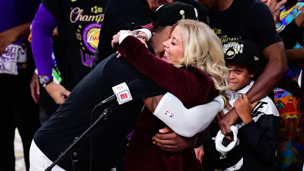 LeBron James #23 and owner Jeanie Buss of the Los Angeles Lakers hug after winning the 2020 NBA Championship Final over the Miami Heat. Douglas P. DeFelice/Getty Images