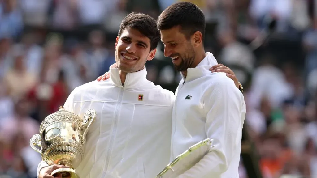 Carlos Alcaraz of Spain with the trophy alongside runner up Novak Djokovic of Serbia after Wimbledon final. Julian Finney/Getty Images