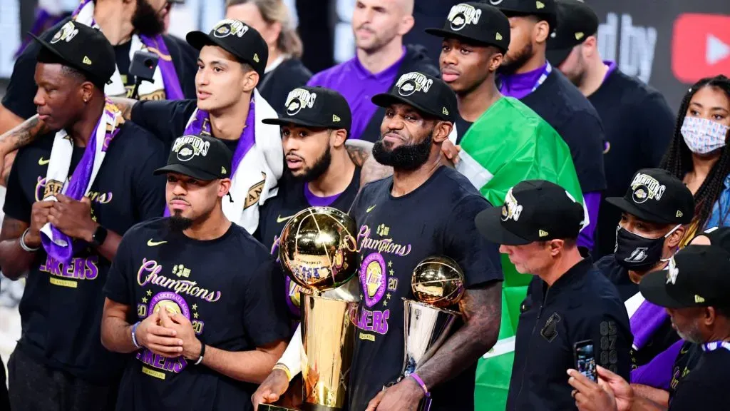 LeBron James #23 of the Los Angeles Lakers reacts with his MVP trophy and Finals trophy after winning the 2020 NBA Championship over the Miami Heat. Douglas P. DeFelice/Getty Images