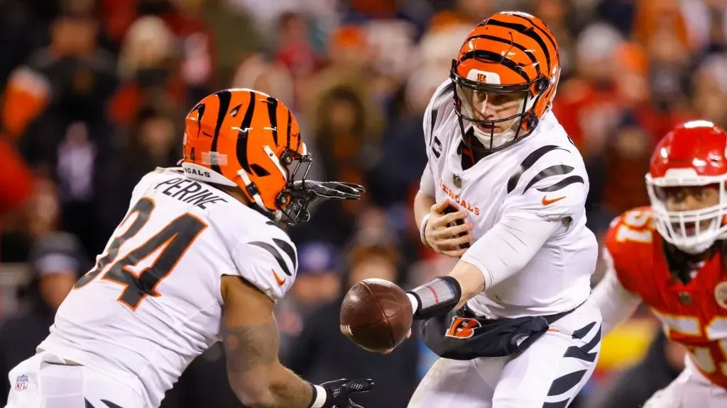 Joe Burrow #9 of the Cincinnati Bengals hands off the ball to Samaje Perine #34 during the second quarter against the Kansas City Chiefs in the AFC Championship Game at GEHA Field at Arrowhead Stadium on January 29, 2023 in Kansas City, Missouri.