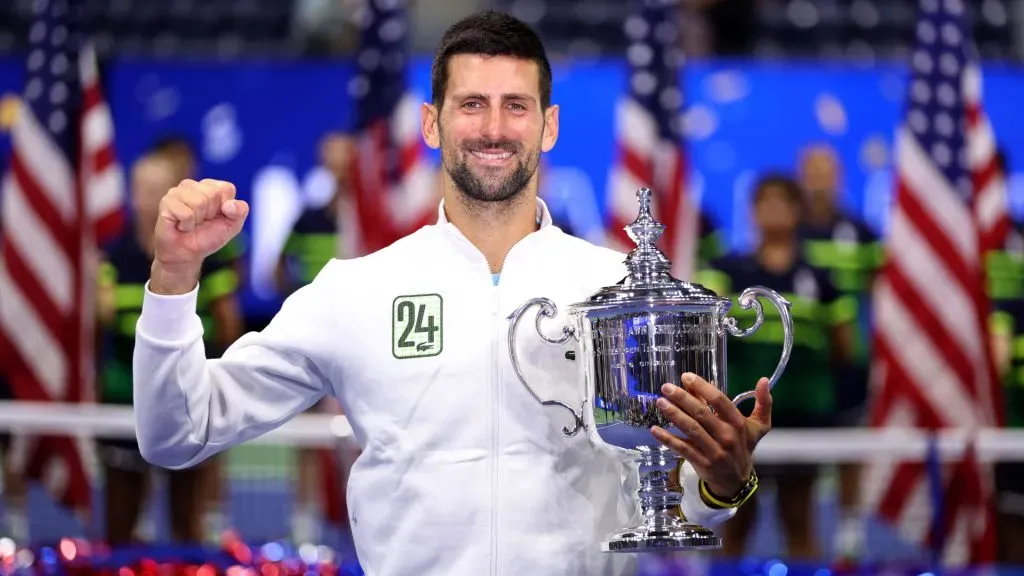 Novak Djokovic of Serbia celebrates winning his 24th Grand Slam with his winners trophy after defeating Daniil Medvedev. Clive Brunskill/Getty Images