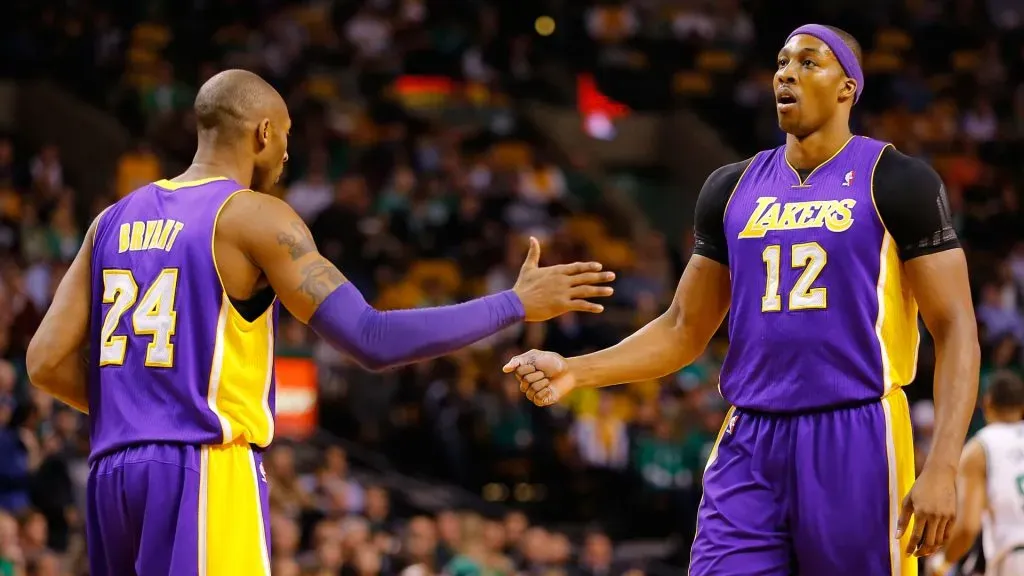Dwight Howard #12 of the Los Angeles Lakers is congratulated by teammate Kobe Bryant #24 of the Los Angeles Lakers against the Boston Celtics. Jared Wickerham/Getty Images
