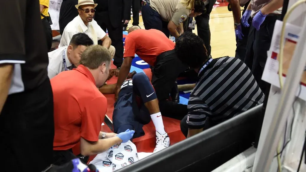Paul George #29 of the 2014 USA Basketball Menās National Team is tended to as he lies on the court after badly injuring his leg defending a play during a USA Basketball showcase. Ethan Miller/Getty Images