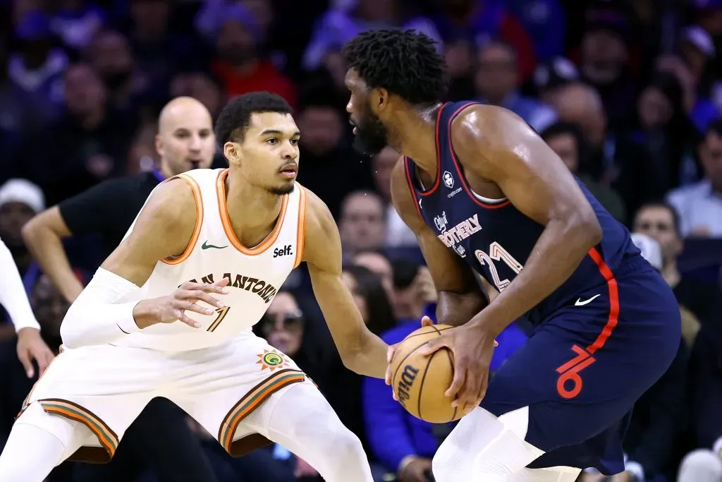 Victor Wembanyama #1 of the San Antonio Spurs guards Joel Embiid #21 of the Philadelphia 76ers. Tim Nwachukwu/Getty Images