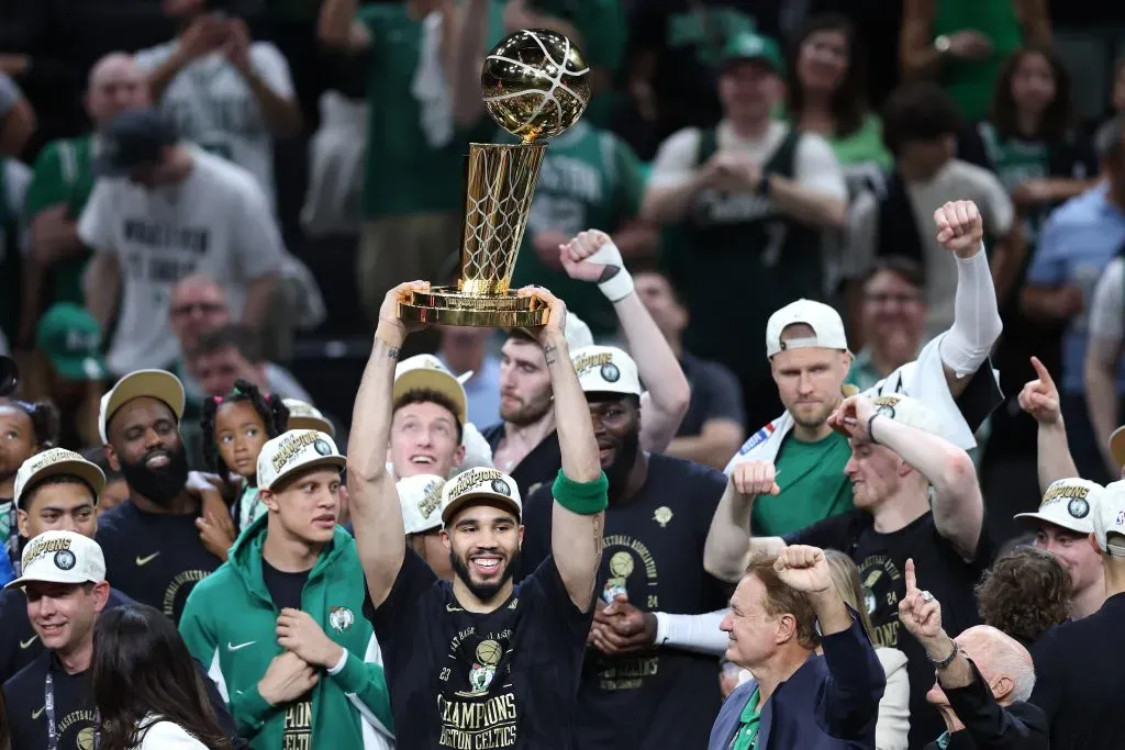 Jayson Tatum #0 of the Boston Celtics lifts the Larry OāBrien Championship Trophy. Adam Glanzman/Getty Images