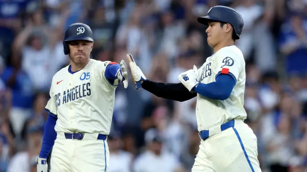 Shohei Ohtani #17 of the Los Angeles Dodgers high fives teammate Freddie Freeman #5 at home plate after a run scored in during the fourth inning against the Tampa Bay Rays at Dodger Stadium. (Photo by Katelyn Mulcahy/Getty Images)