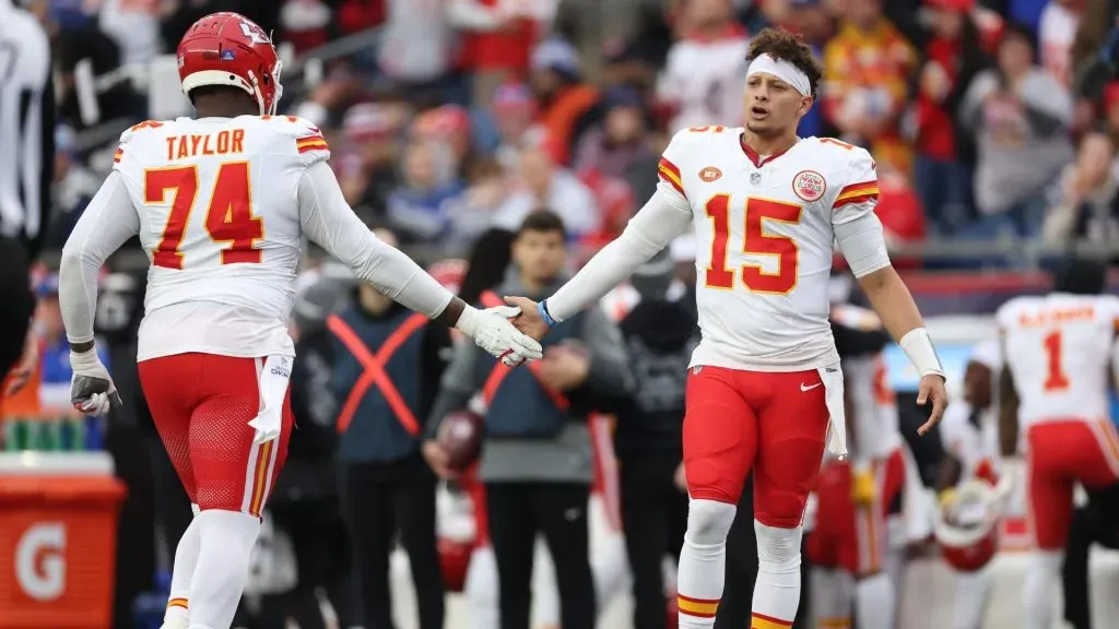 Patrick Mahomes #15 of the Kansas City Chiefs high fives Jawaan Taylor #74 of the Kansas City Chiefs during the third quarter against the New England Patriots at Gillette Stadium on December 17, 2023 in Foxborough, Massachusetts.