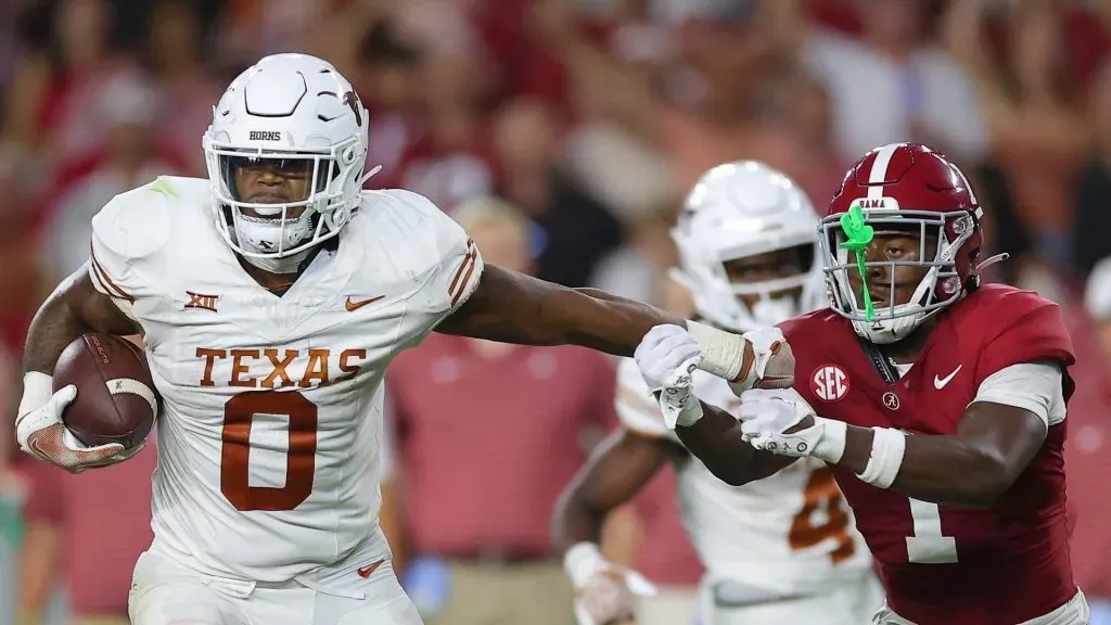 Anthony Hill Jr. #0 of the Texas Longhorns avoids a tackle by Kool-Aid McKinstry #1 of the Alabama Crimson Tide during the fourth quarter at Bryant-Denny Stadium on September 09, 2023 in Tuscaloosa, Alabama.