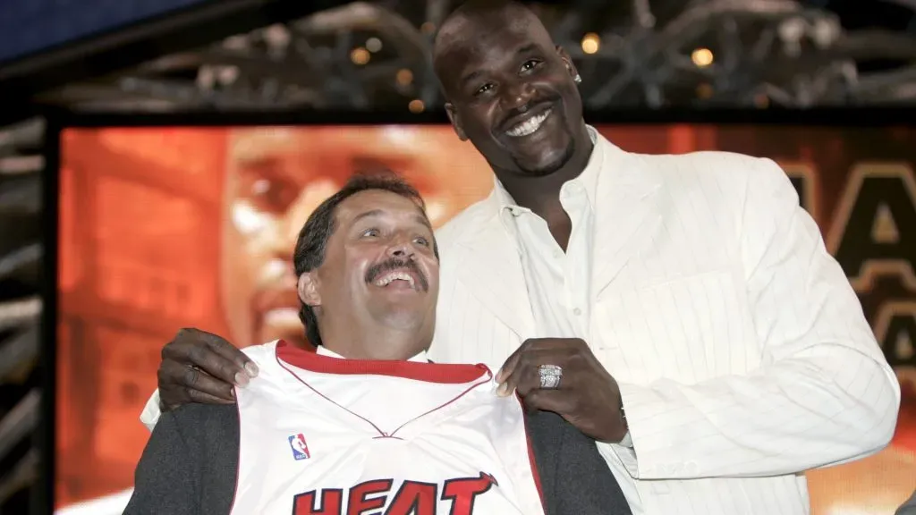 Shaquille O'Neal of the Miami Heat holds up his new #32 jersey over Coach Stan Van Gundy (L) during a press conference to offically announce his arrival to the Miami Heat July 20, 2004 at the American Airlines Arena in Miami, Florida. O'Neal was traded from the Los Angeles Lakers to the Heat for Lamar Odom, Brian Grant, Caron Butler and a future first-round draft pick on July 14.