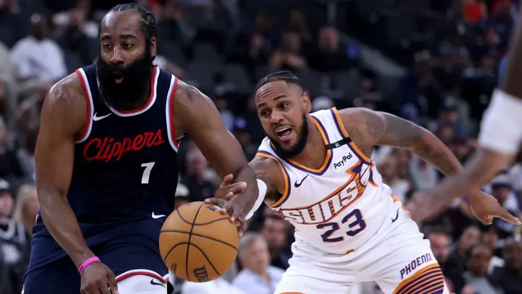 James Harden #1 of the LA Clippers dribbles away from Monte Morris #23 of the Phoenix Suns during the first half in the season home opening game at Intuit Dome on October 23, 2024 in Inglewood, California. (Photo by Harry How/Getty Images)
