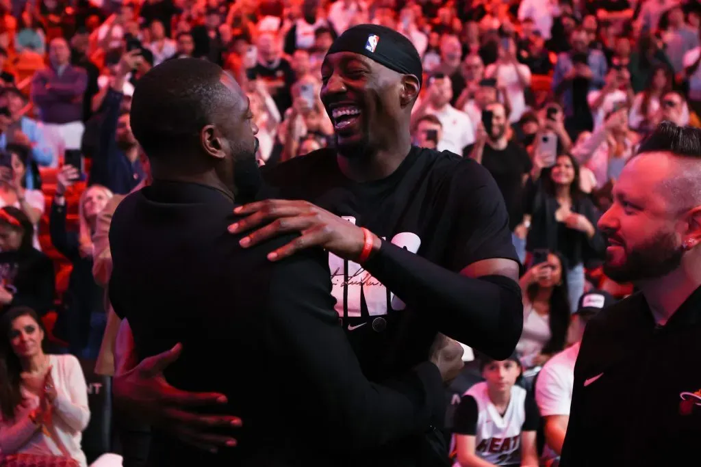 Former Miami Heat player Dwyane Wade and Bam Adebayo #13 of the Heat embrace during halftime of a game against the Charlotte Hornets. Megan Briggs/Getty Images