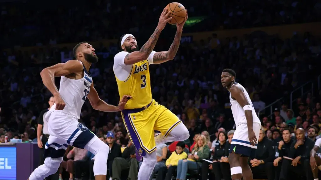 Anthony Davis #3 of the Los Angeles Lakers drives to the basket past Rudy Gobert #27 of the Minnesota Timberwolves during a 110-103 win in the season home opener at Crypto.com Arena on October 22, 2024 in Los Angeles, California.