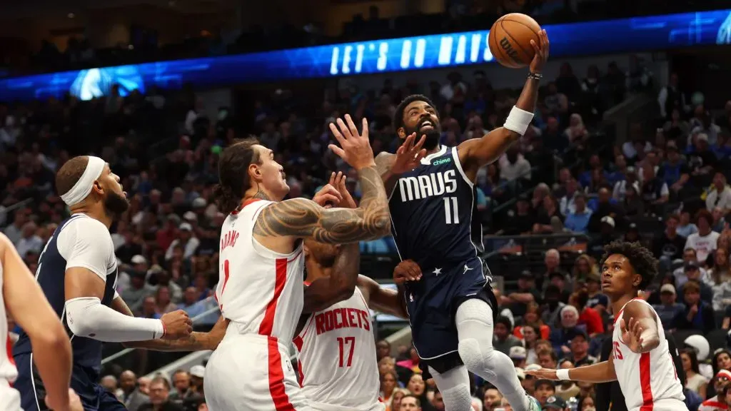 Kyrie Irving #11 of the Dallas Mavericks goes up for a shot against Steven Adams #12 of the Houston Rockets and Tari Eason #17. Richard Rodriguez/Getty Images