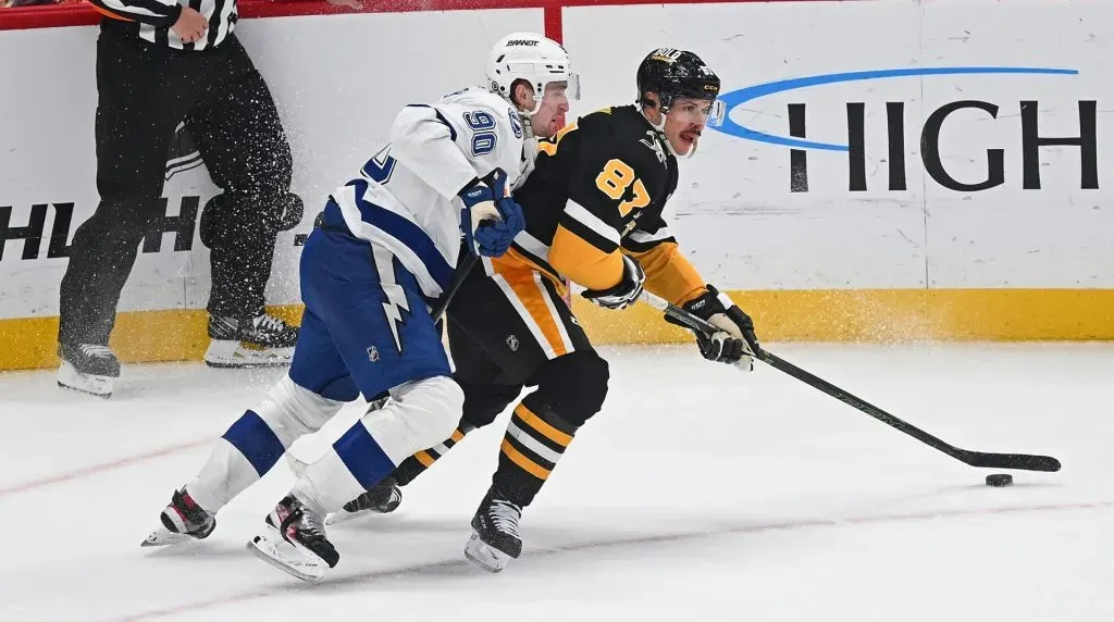 Sidney Crosby #87 of the Pittsburgh Penguins skates with the puck against J.J. Moser #90 of the Tampa Bay Lightning in overtime during the game at PPG PAINTS Arena on November 19, 2024 in Pittsburgh, Pennsylvania. (Photo by Justin Berl/Getty Images)