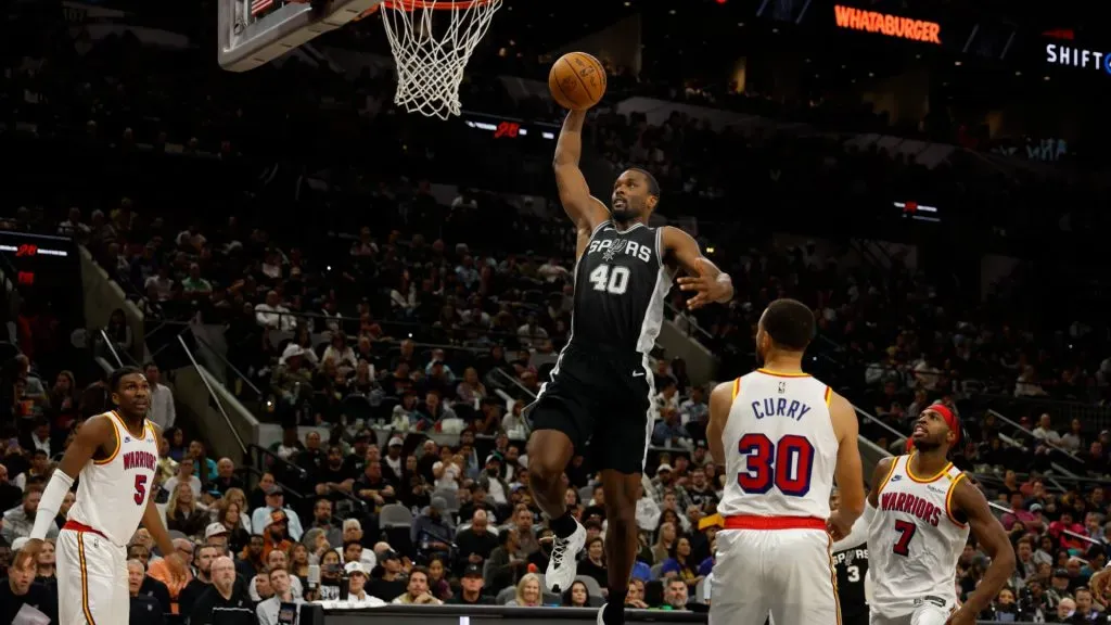 Harrison Barnes #40 of the San Antonio Spurs dunks past Buddy Hield #7 of the Golden State Warriors in the second half at Frost Bank Center. (Ronald Cortes/Getty Images)