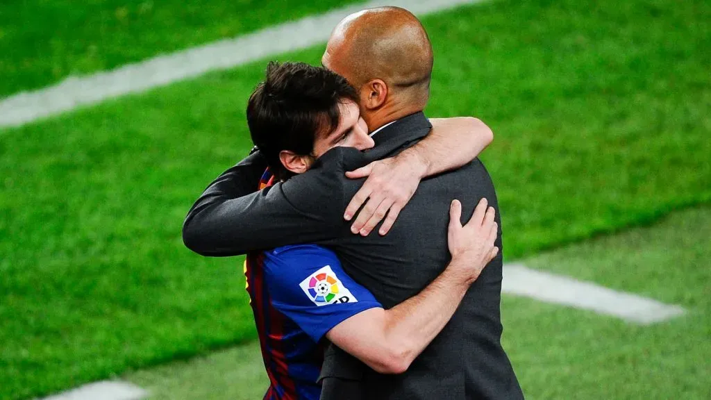 Lionel Messi of FC Barcelona (R) hugs his Head coach Josep Guardiola of FC Barcelona after scoring his team’s third goal during the La Liga match between FC Barcelona and RCD Espanyol. (David Ramos/Getty Images)