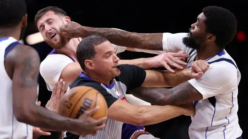 Naji Marshall #13 of the Dallas Mavericks punches Jusuf Nurkic #20 of the Phoenix Suns during the second half at Footprint Center. (Chris Coduto/Getty Images)
