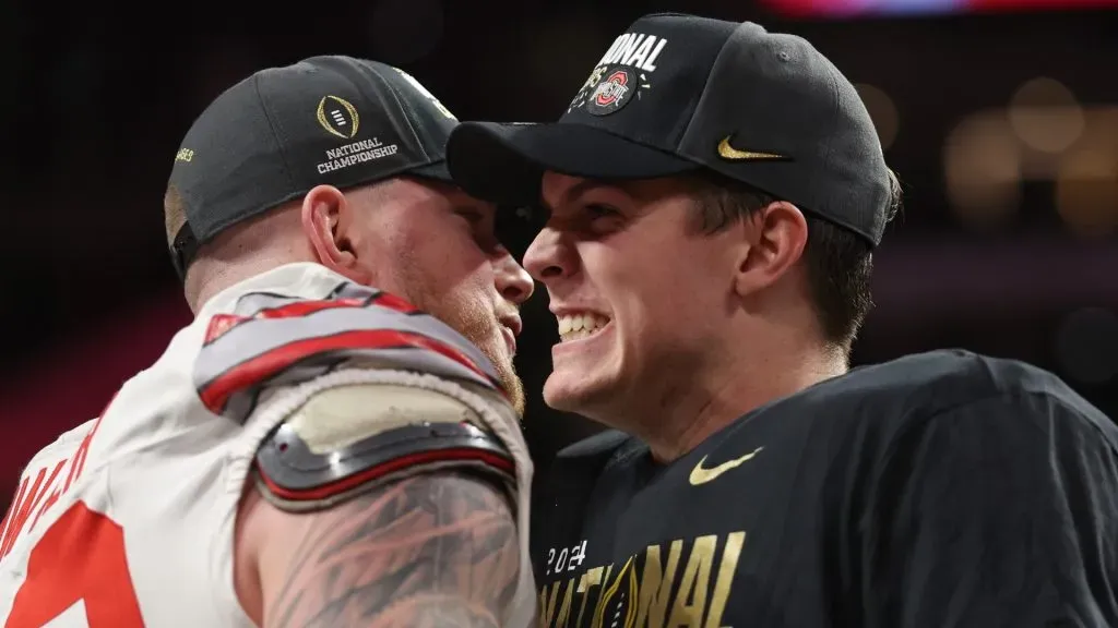 Jack Sawyer #33 and Will Howard #18 of the Ohio State Buckeyes celebrate after defeating the Notre Dame Fighting Irish 34-23 in the 2025 CFP National Championship at the Mercedes-Benz Stadium on January 20, 2025 in Atlanta, Georgia.