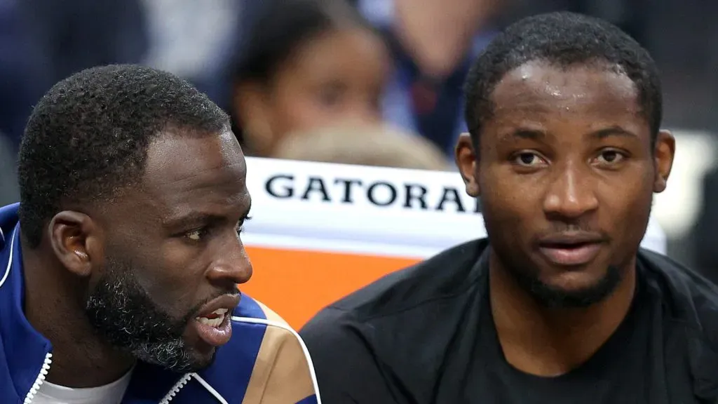 Draymond Green #23 (left) speaks to Jonathan Kuminga #00 of the Golden State Warriors