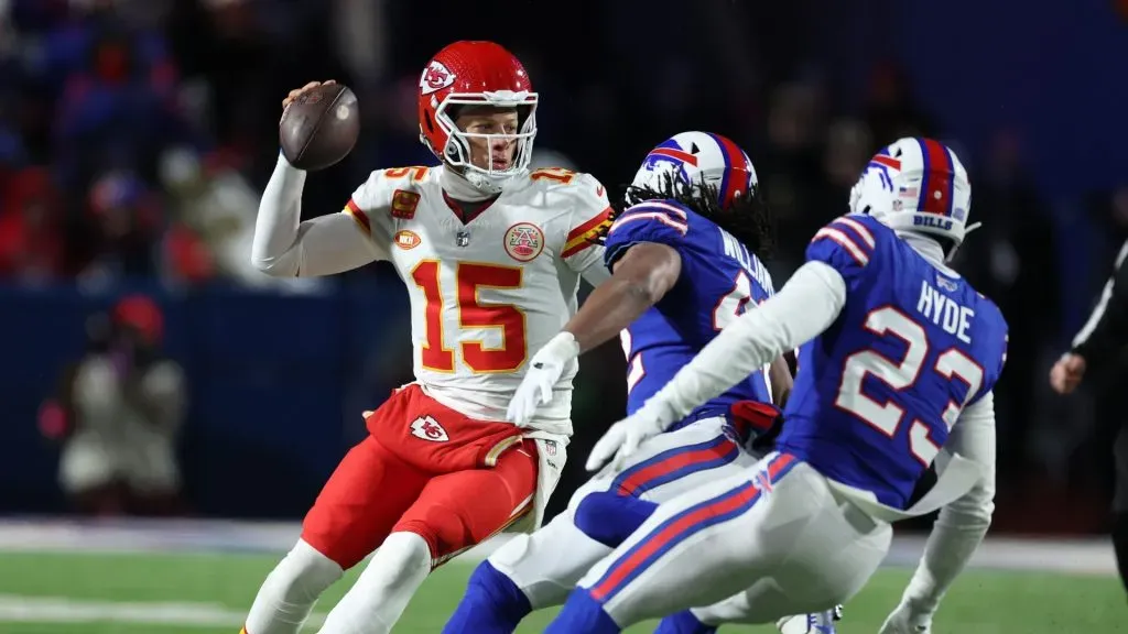 Patrick Mahomes #15 of the Kansas City Chiefs dodges Micah Hyde #23 of the Buffalo Bills during their AFC Divisional Playoff game at Highmark Stadium on January 21, 2024 in Orchard Park, New York.