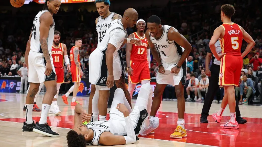 Victor Wembanyama of the San Antonio Spurs reacts with Chris Paul and De’Aaron Fox after drawing a foul against the Atlanta Hawks on February 05, 2025.