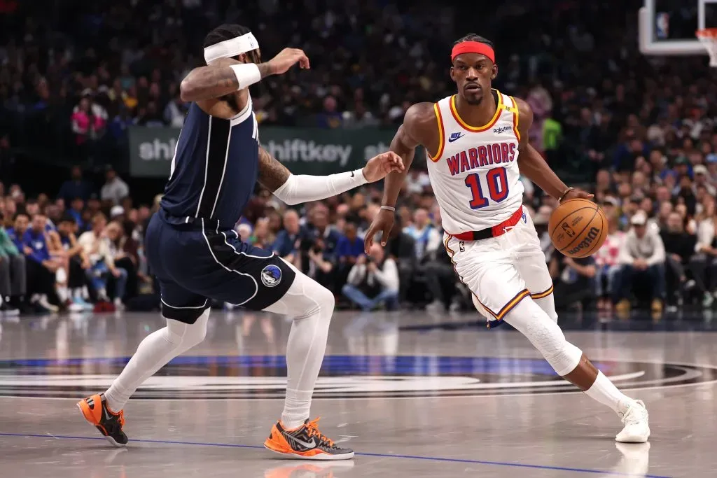 Jimmy Butler #10 of the Golden State Warriors is defended by Jaden Hardy #1 of the Dallas Mavericks