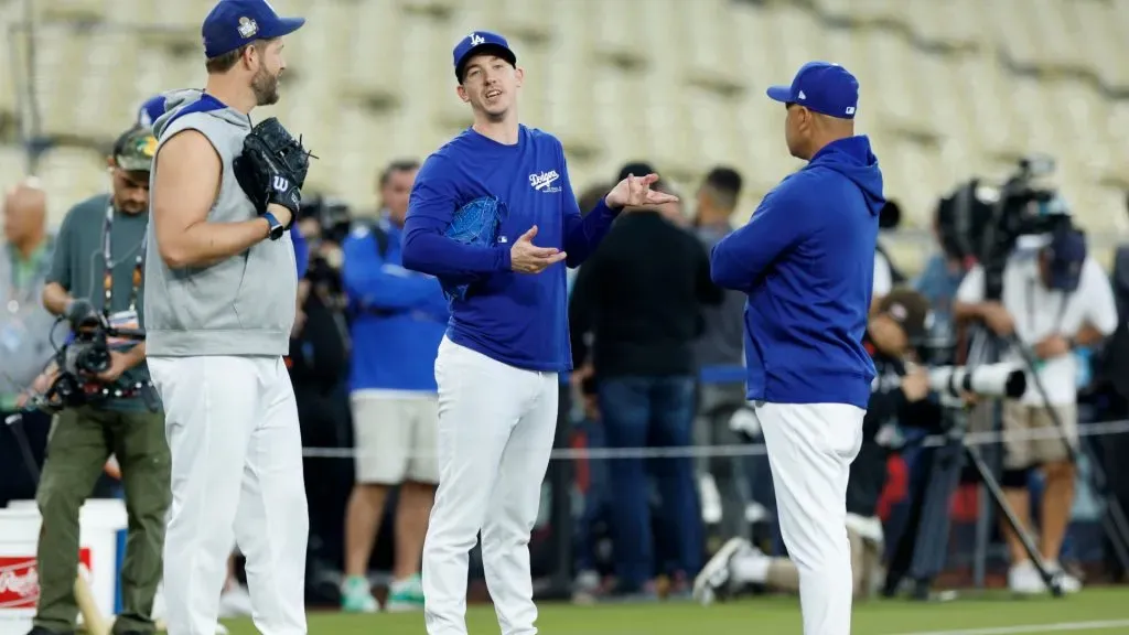 Clayton Kershaw #22, Walker Buehler #21, and Dave Roberts #30 of the Los Angeles Dodgers talk during workout day ahead of Game 1 of the 2024 World Series at Dodger Stadium on October 24, 2024 in Los Angeles, California. (Photo by Kevork Djansezian/Getty Images)