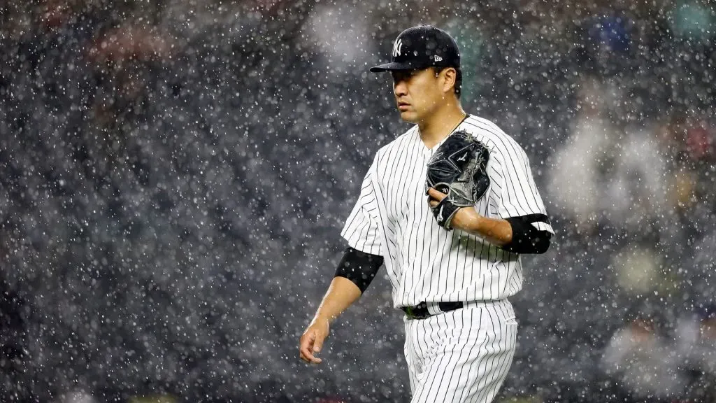 Masahiro Tanaka #19 of the New York Yankees walks off the field as the tarp is put on the field for a rain delay against the Seattle Mariners at Yankee Stadium on May 07, 2019. (Source: Mike Stobe/Getty Images)