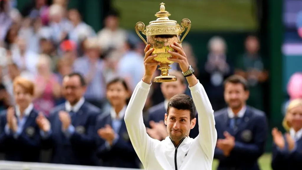 Novak Djokovic lifts the 2019 Wimbledon trophy after winning his Men’s Singles final against Roger Federer.. (Matthias Hangst/Getty Images)