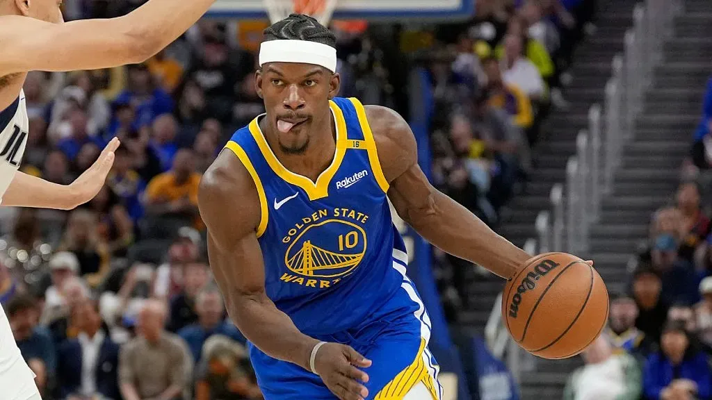 Jimmy Butler III #10 of the Golden State Warriors dribbles the ball to the basket on Dante Exum #0 of the Dallas Mavericks