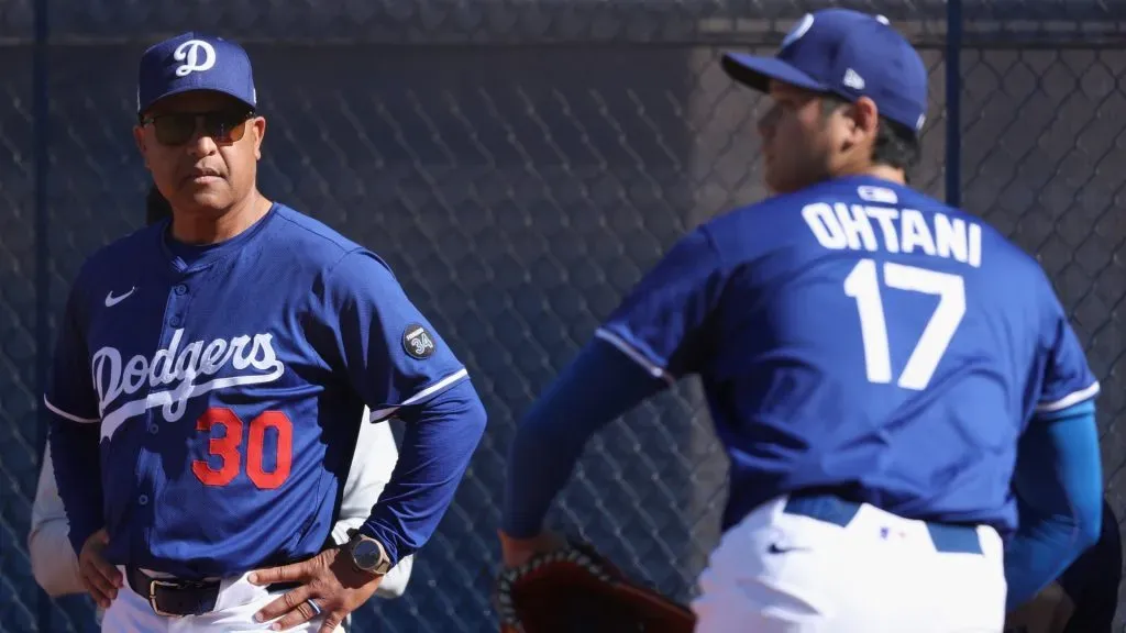 Manager Dave Roberts #30 of the Los Angeles Dodgers looks on as pitcher Shohei Ohtani #17 throws in the bullpen during a team workout at Camelback Ranch on February 15, 2025 in Glendale, Arizona. (Photo by Christian Petersen/Getty Images)