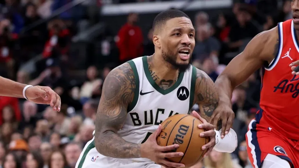 Damian Lillard #0 of the Milwaukee Bucks drives to the basket between Terance Mann #14 ad Nicolas Batum #33 of the LA Clippers