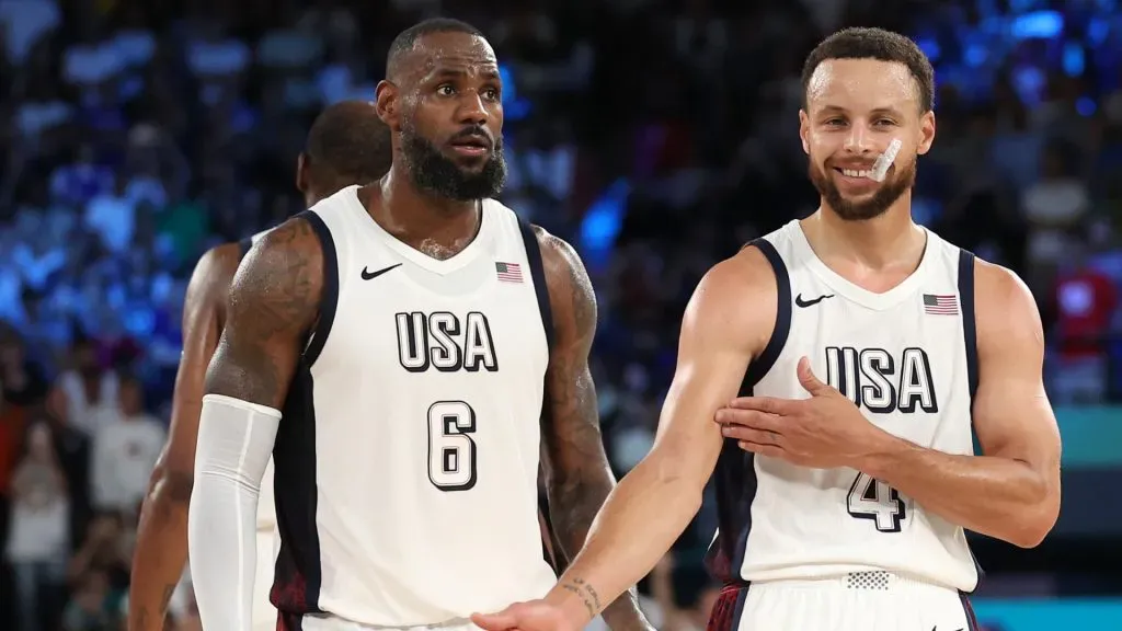 LeBron James #6 of Team United States watches as Stephen Curry #4 of Team United States celebrates towards his bench