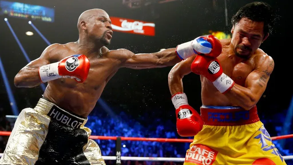 Floyd Mayweather Jr. throws a left at Manny Pacquiao during their welterweight unification championship bout on May 2, 2015. (Source: Al Bello/Getty Images)