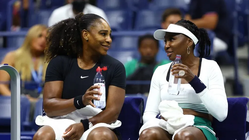 Serena and Venus talk during a changeover in the 2022 US Open ( Elsa/Getty Images)