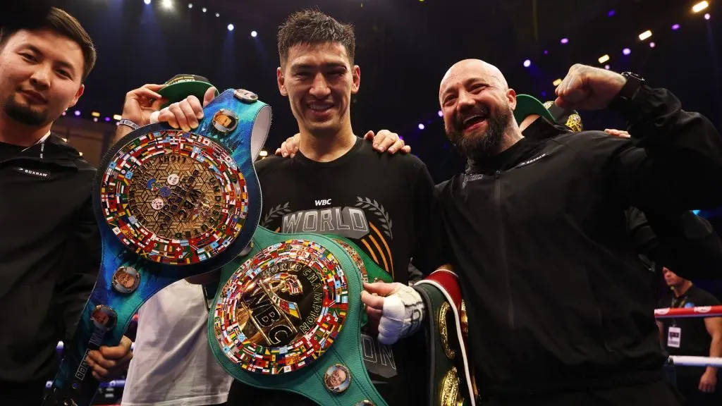 Dmitrii Bivol celebrates victory with the title belts and his team after the Undisputed IBF, IBO, WBC and WBO World Light Heavyweight Titlesâ fight between Artur Beterbiev and Dmitrii Bivol as part of Beterbiev v Bivol 2. (Photo by Richard Pelham/Getty Images)