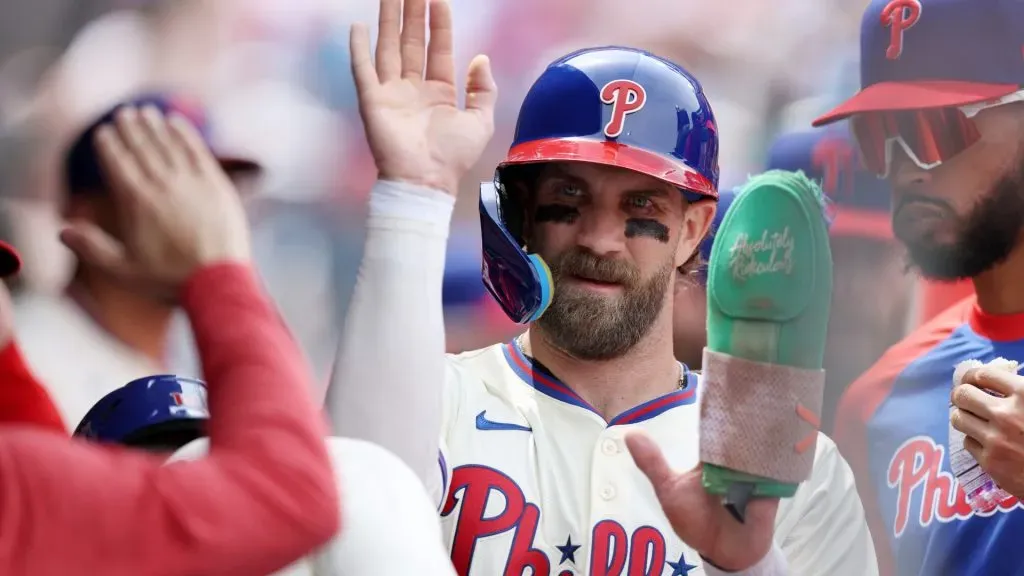 Bryce Harper #3 of the Philadelphia Phillies celebrates in the dugout after scoring on an RBI double by Max Kepler #17 in the third inning against the Miami Marlins in 2025. (Source: Emilee Chinn/Getty Images)
