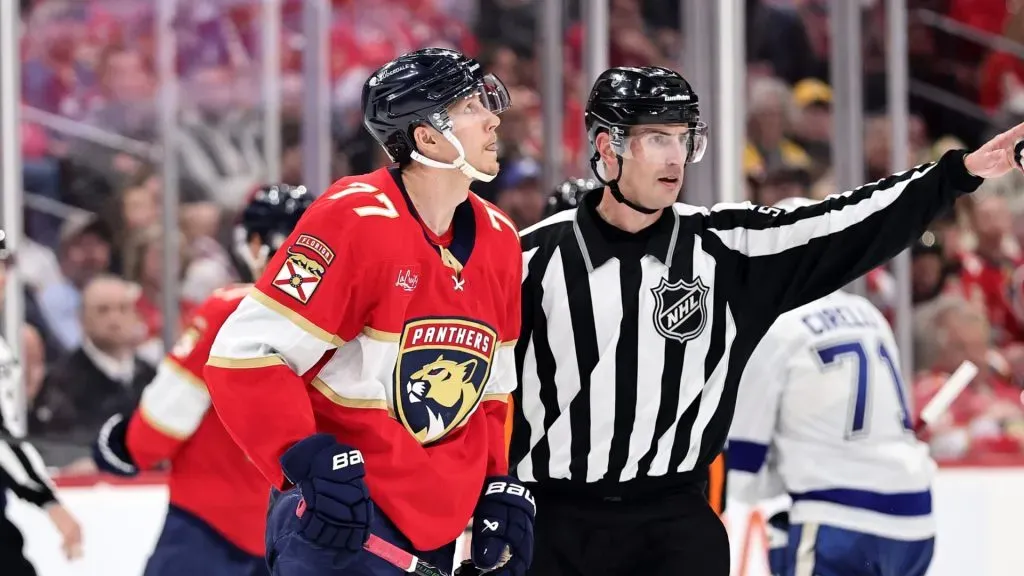 Niko Mikkola #77 of the Florida Panthers is escorted off the ice during the third period against the Tampa Bay Lightning in Game Three of the First Round of the 2025 Stanley Cup Playoffs at Amerant Bank Arena on April 26, 2025 in Sunrise, Florida.