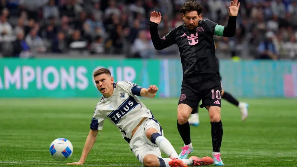 Ranko Veselinović #4 of the Vancouver Whitecaps FC shoots while under pressure from Lionel Messi ( Jeff Vinnick/Getty Images)